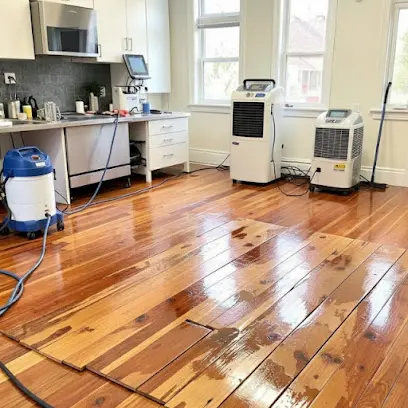 Kitchen cleanup for an Oceanside home, with a wet wood floor, two dehumidifiers and a wet vacuum on the job.