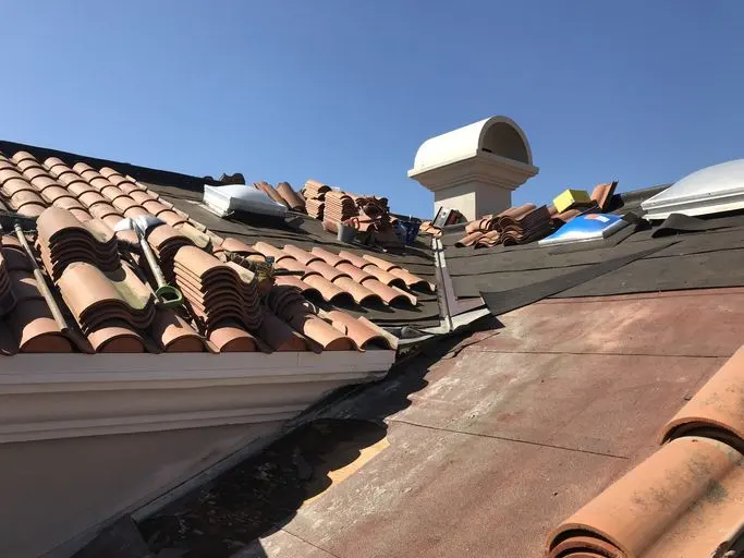 Broken and missing clay roof tiles exposing worn underlayment, a common source of roof leak water damage in Encinitas homes